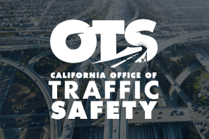 White OTS Traffic Safety logo with interchanging freeway background